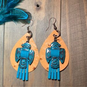 Copper Thunderbird and teal on a butternut ostrich leather earrings.